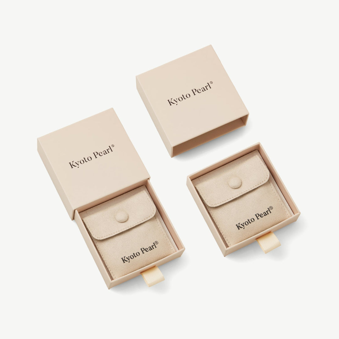 Beige jewelry boxes with Kyoto Pearl branding on a white background