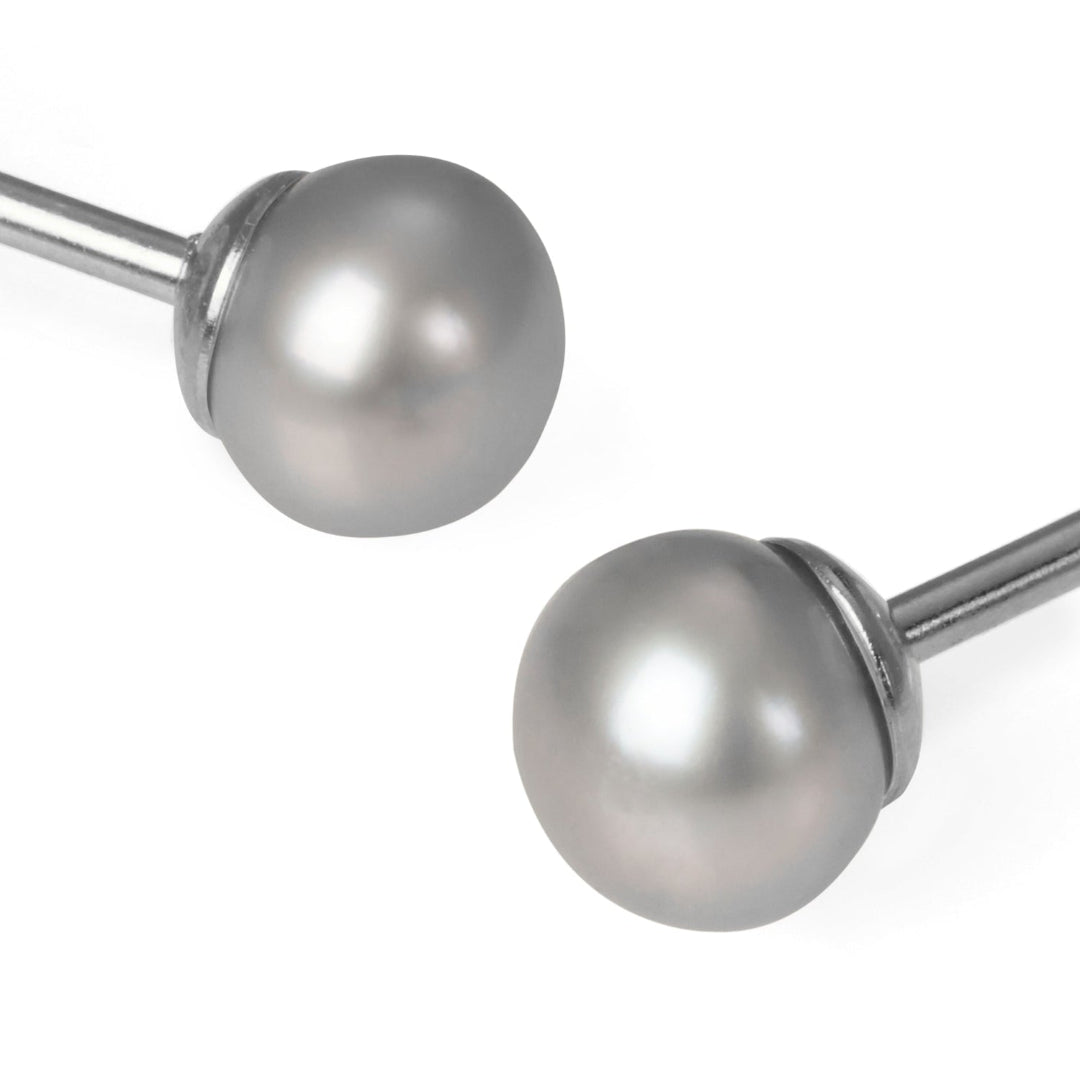 Two metallic curtain rods with spherical ends on a white background