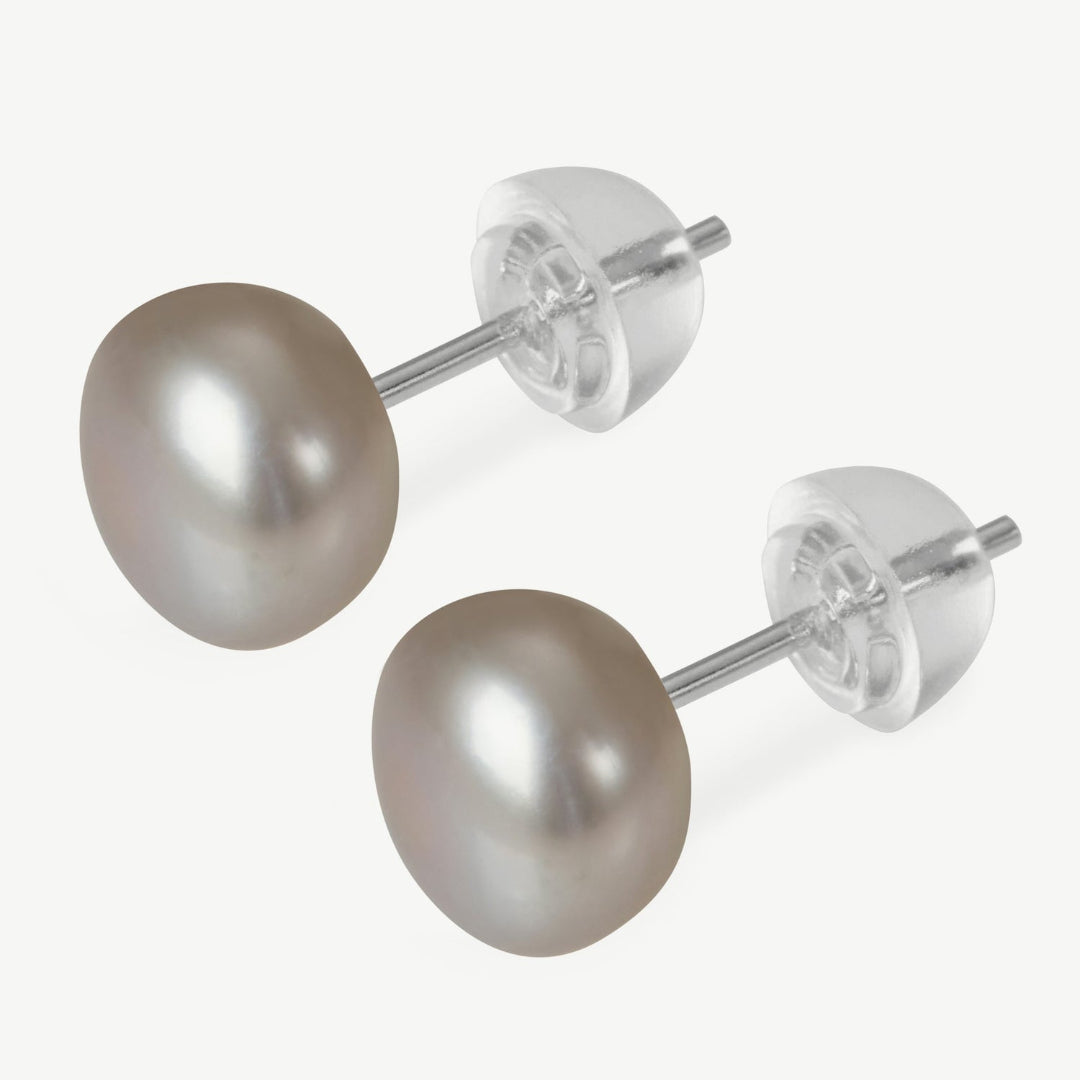 Pair of pearl stud earrings on a white background