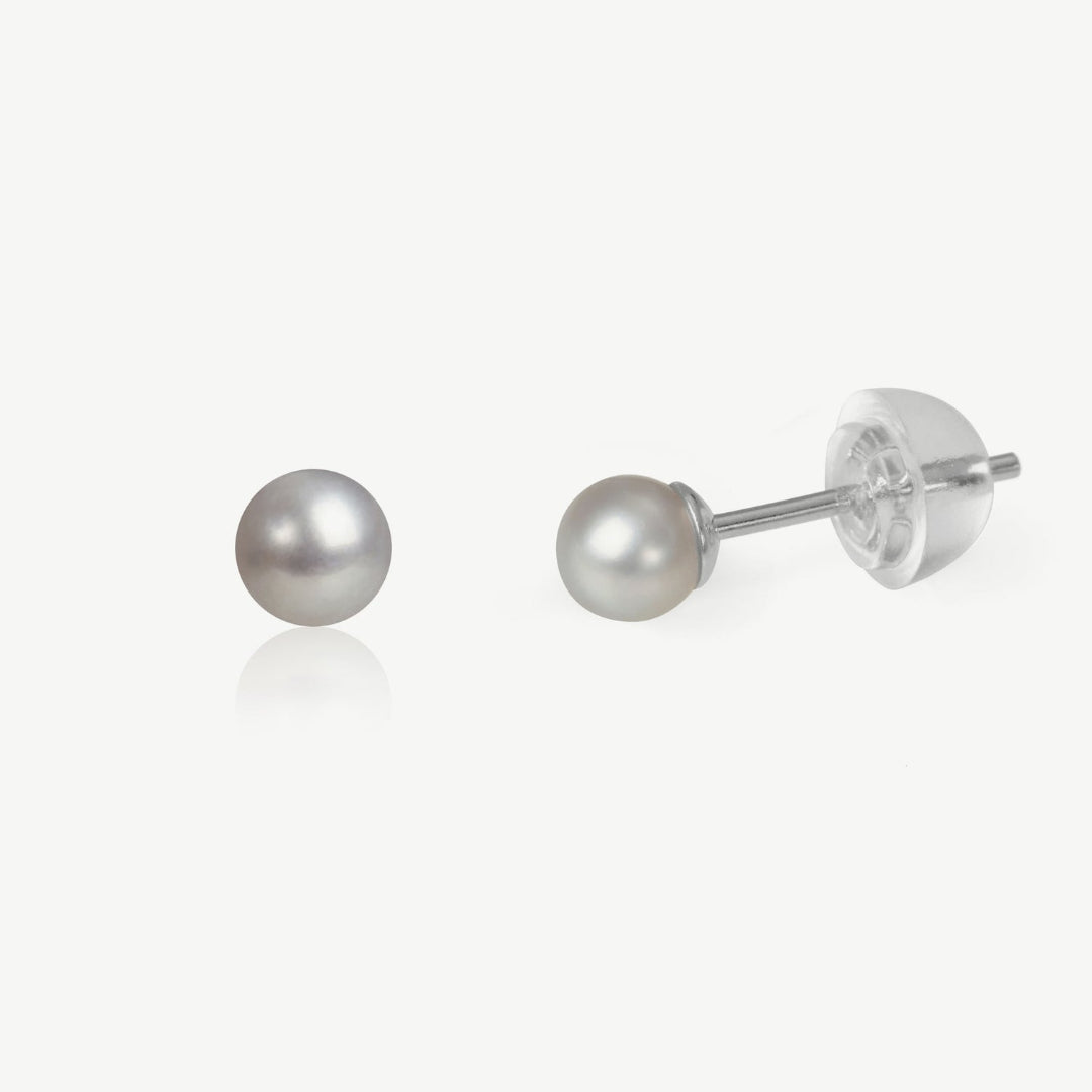 Pair of pearl stud earrings on a white background