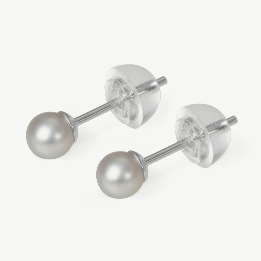 Pair of pearl stud earrings on a white background