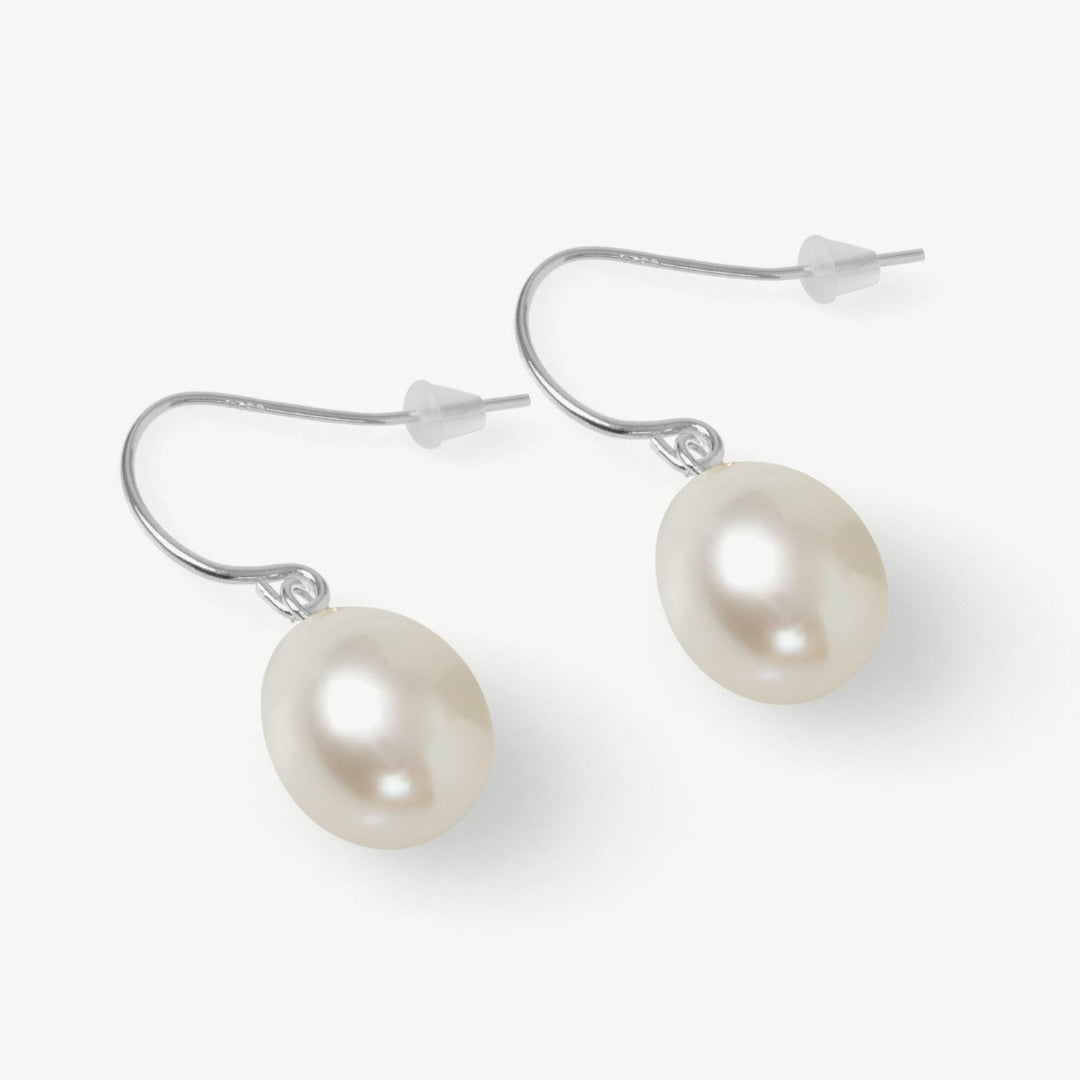 Pearl earrings with gold hooks on a white background
