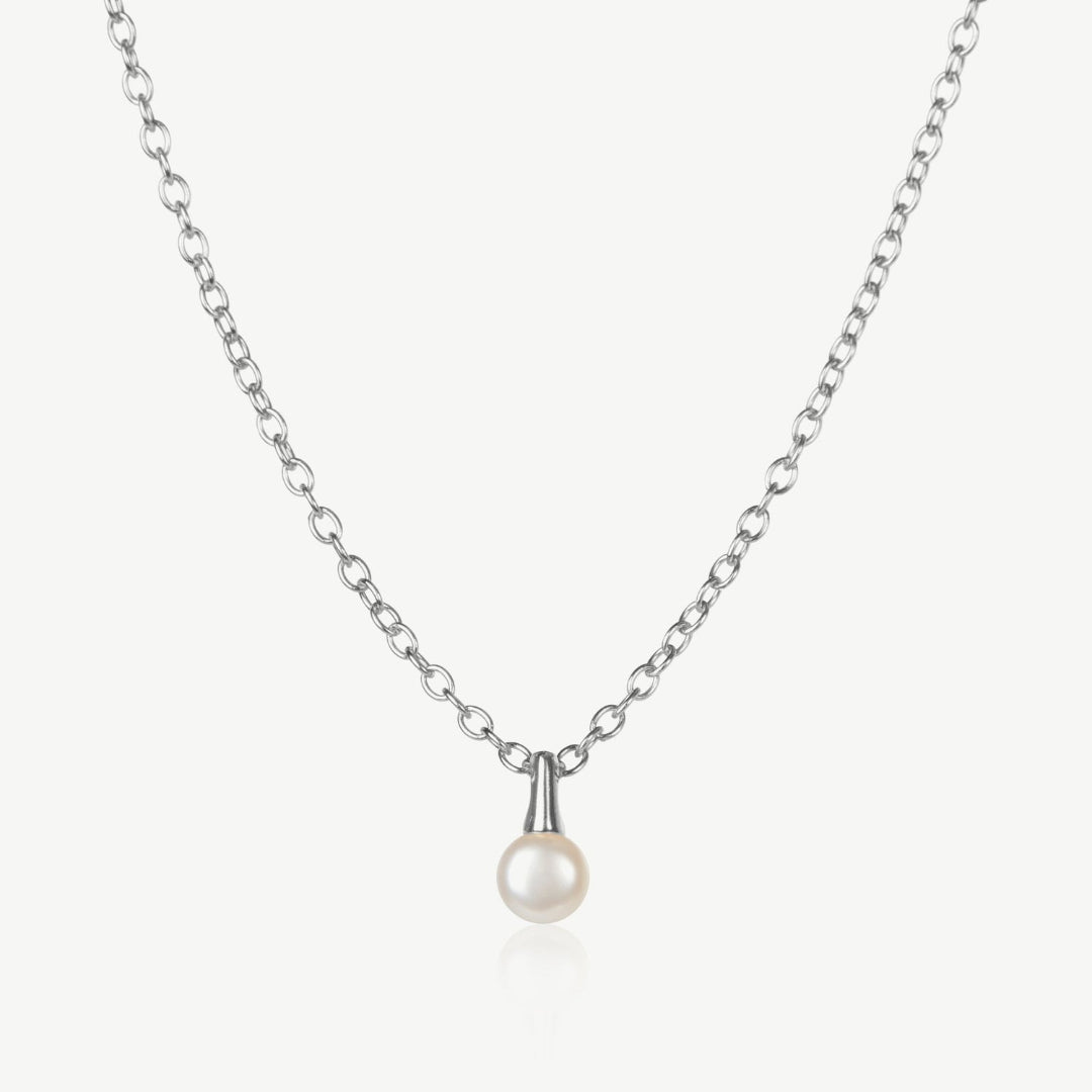 Pearl necklace on a silver chain against a white background