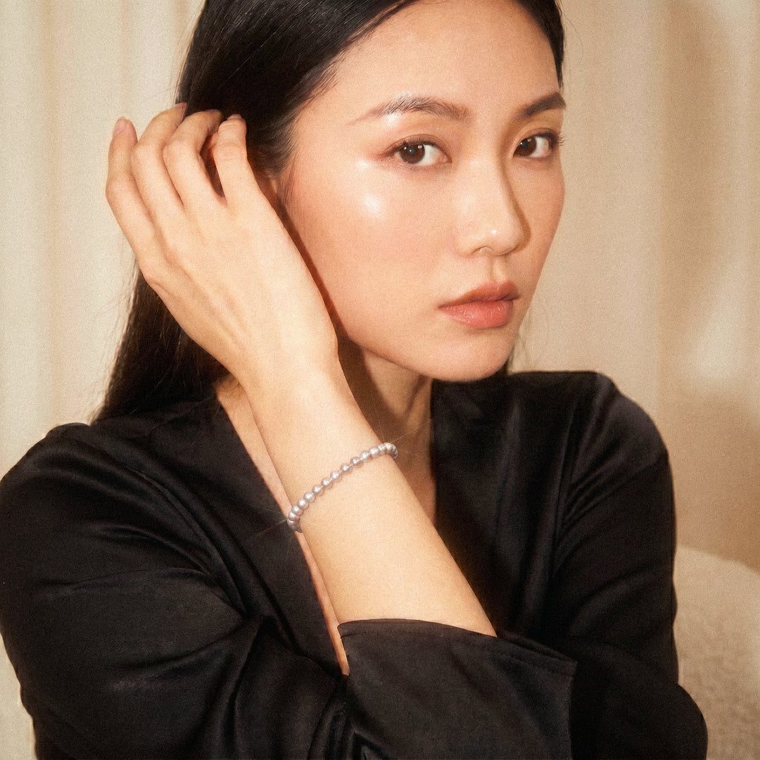Woman wearing a black top with a neutral background