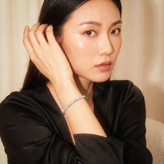 Woman wearing a black top with a neutral background