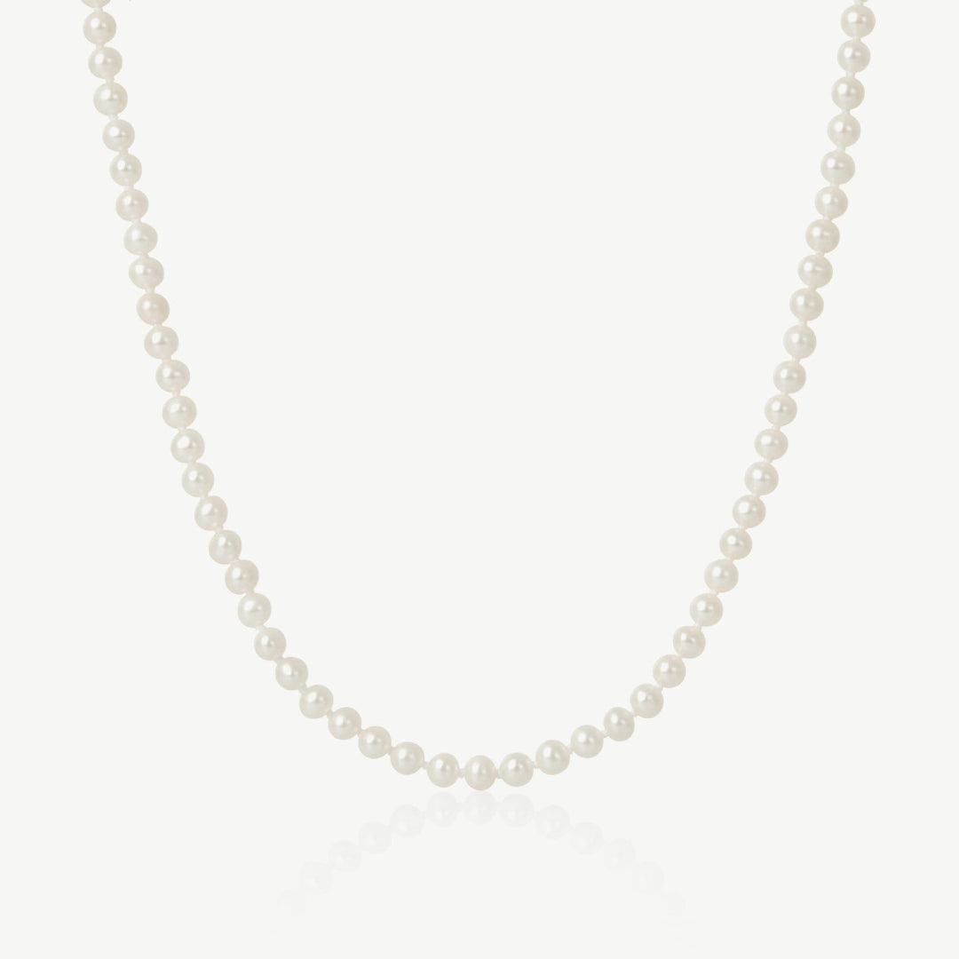 Pearl necklace on a light gray background