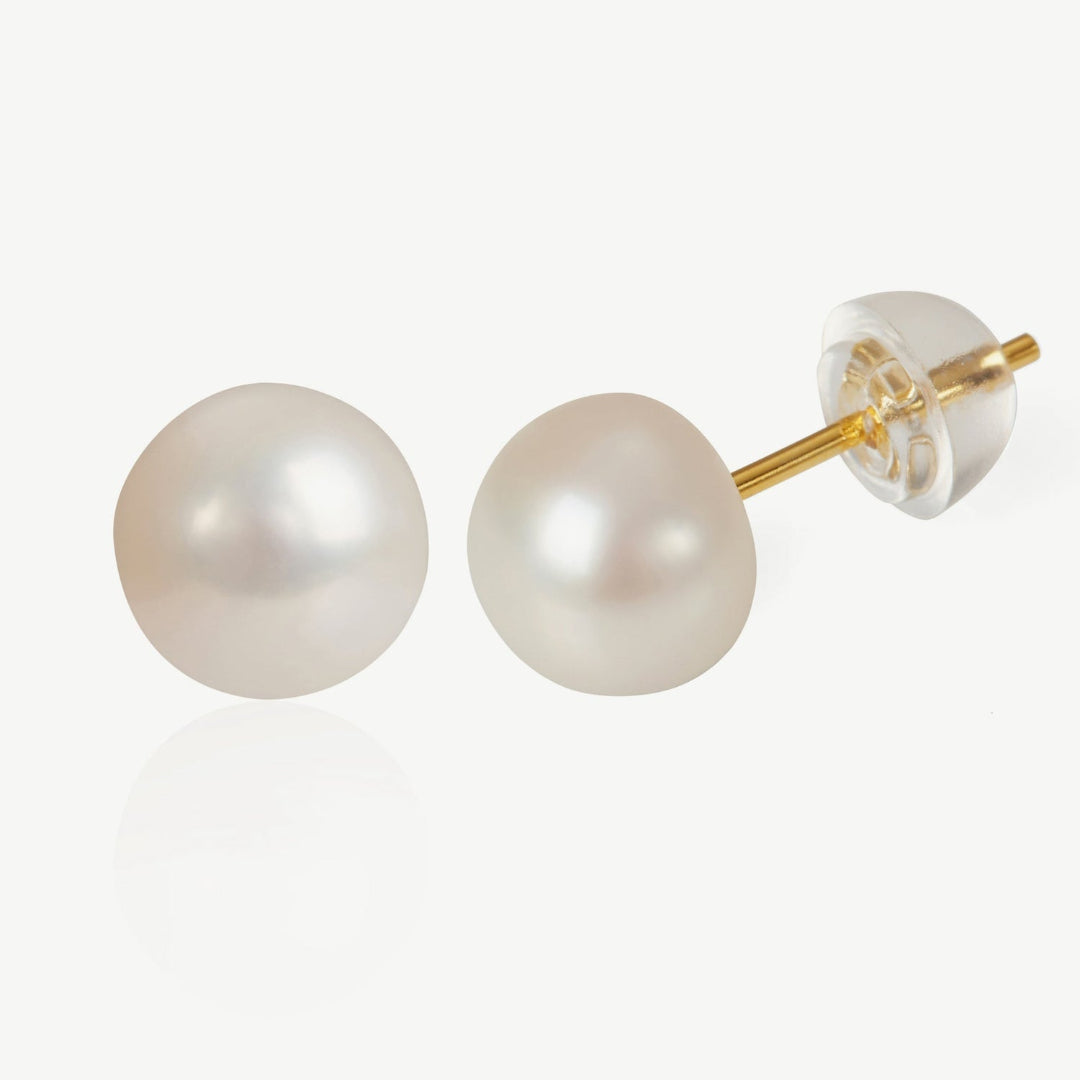 Pearl stud earrings with gold posts on a white background