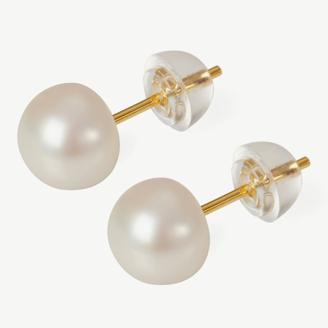 Pearl earrings with gold posts on a white background