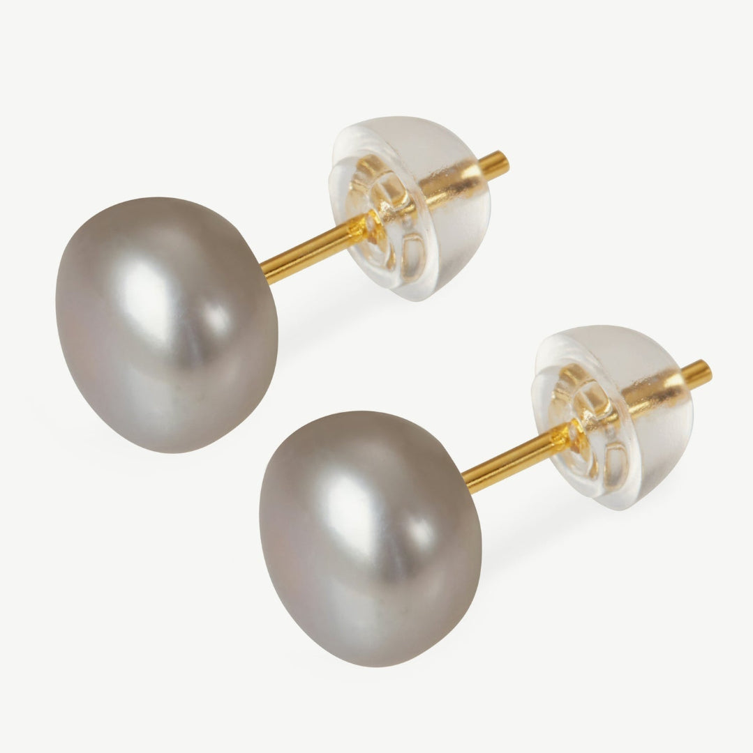 Pearl earrings with gold posts on a white background