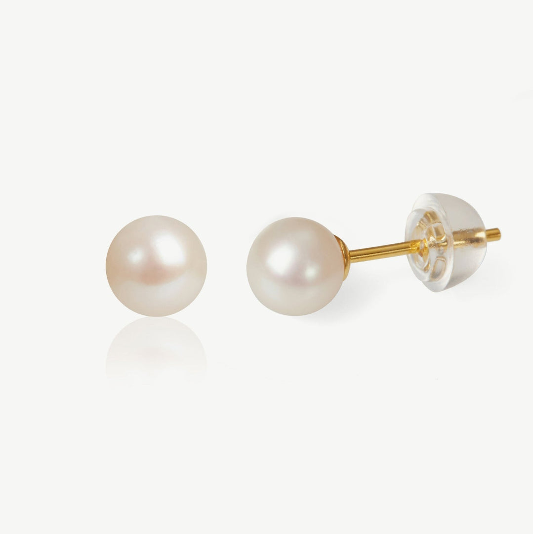 Pair of pearl earrings with gold posts on a white background