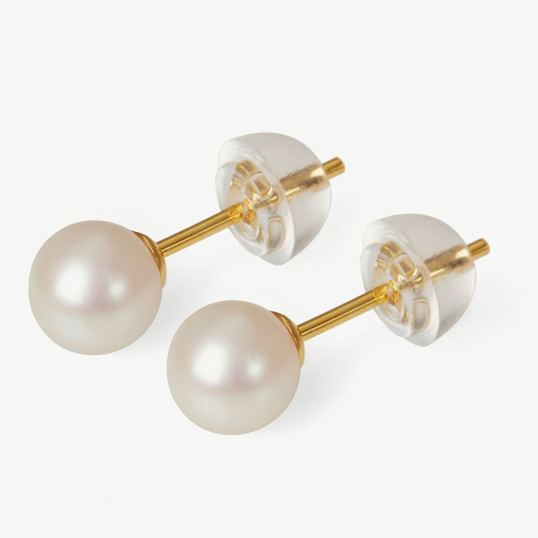 Pearl earrings with gold posts on a white background