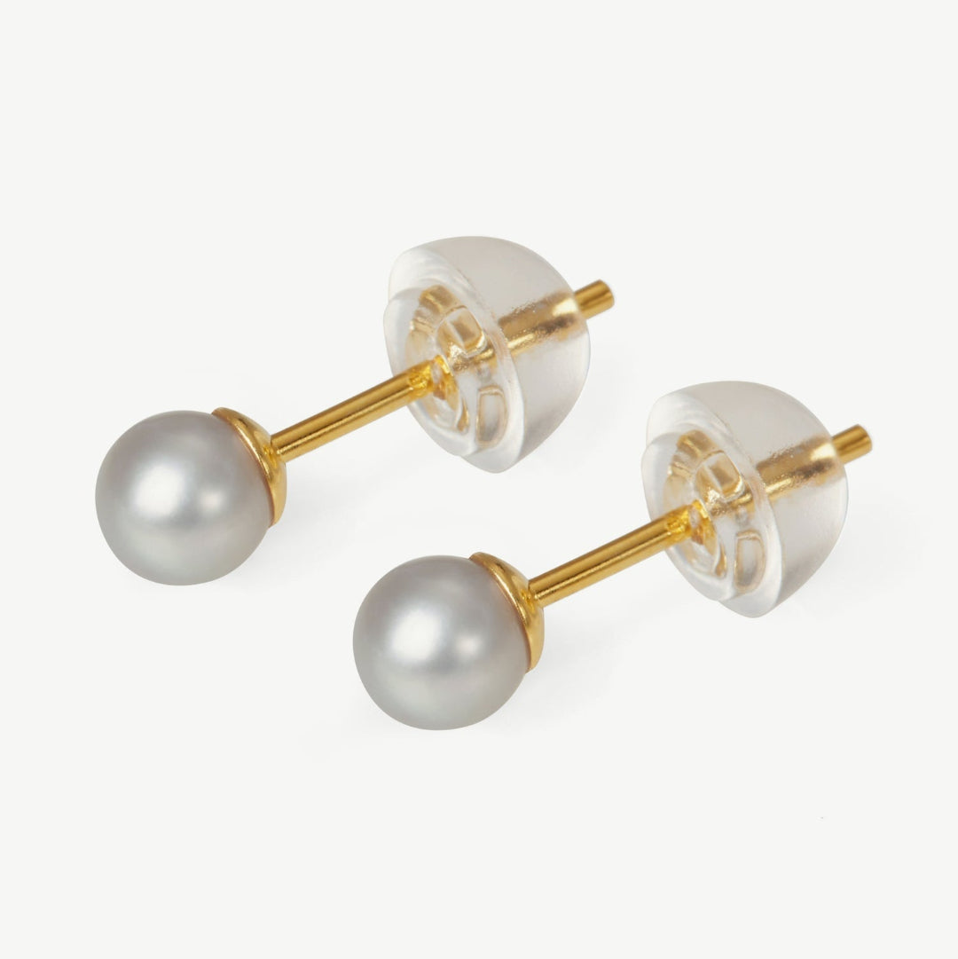 Pair of pearl earrings with gold posts on a white background