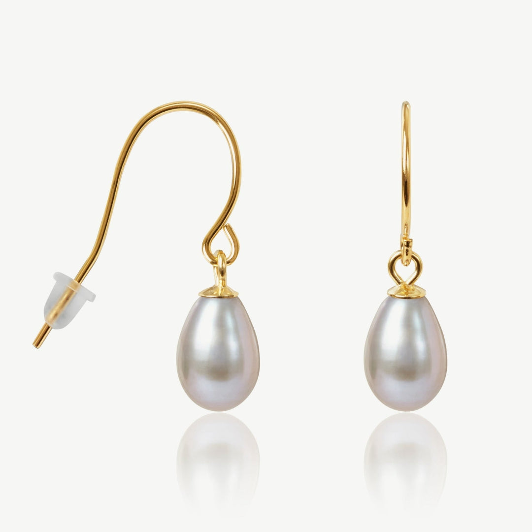 Pearl earrings with gold hooks on a white background