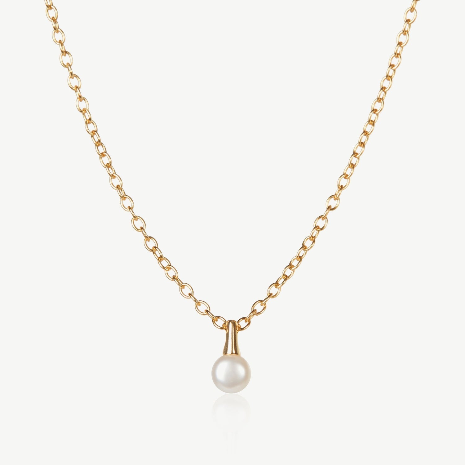 Gold necklace with a pearl pendant on a white background