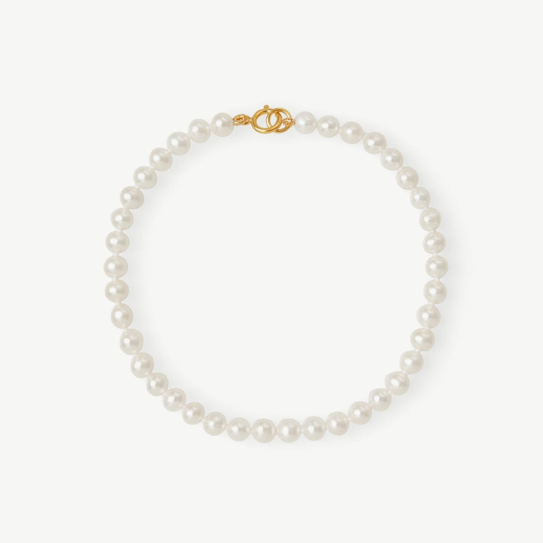 Pearl necklace with a gold clasp on a white background