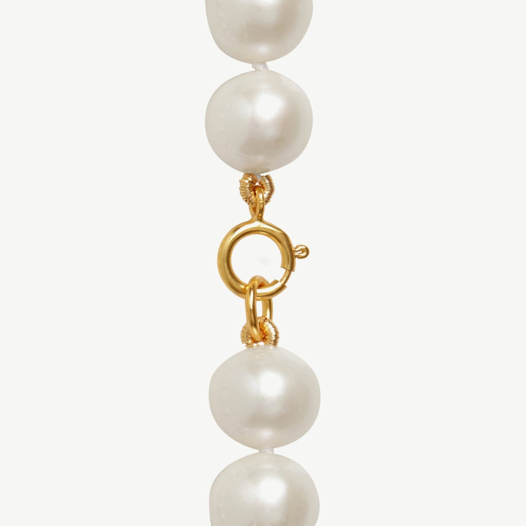 Pearl necklace with a gold clasp on a white background