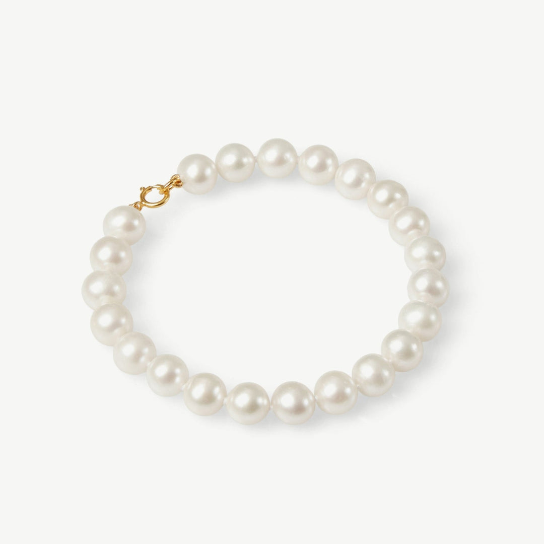 Pearl bracelet with a gold clasp on a white background