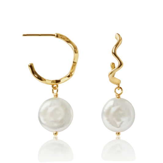 Gold hoop earrings with white pearls on a white background
