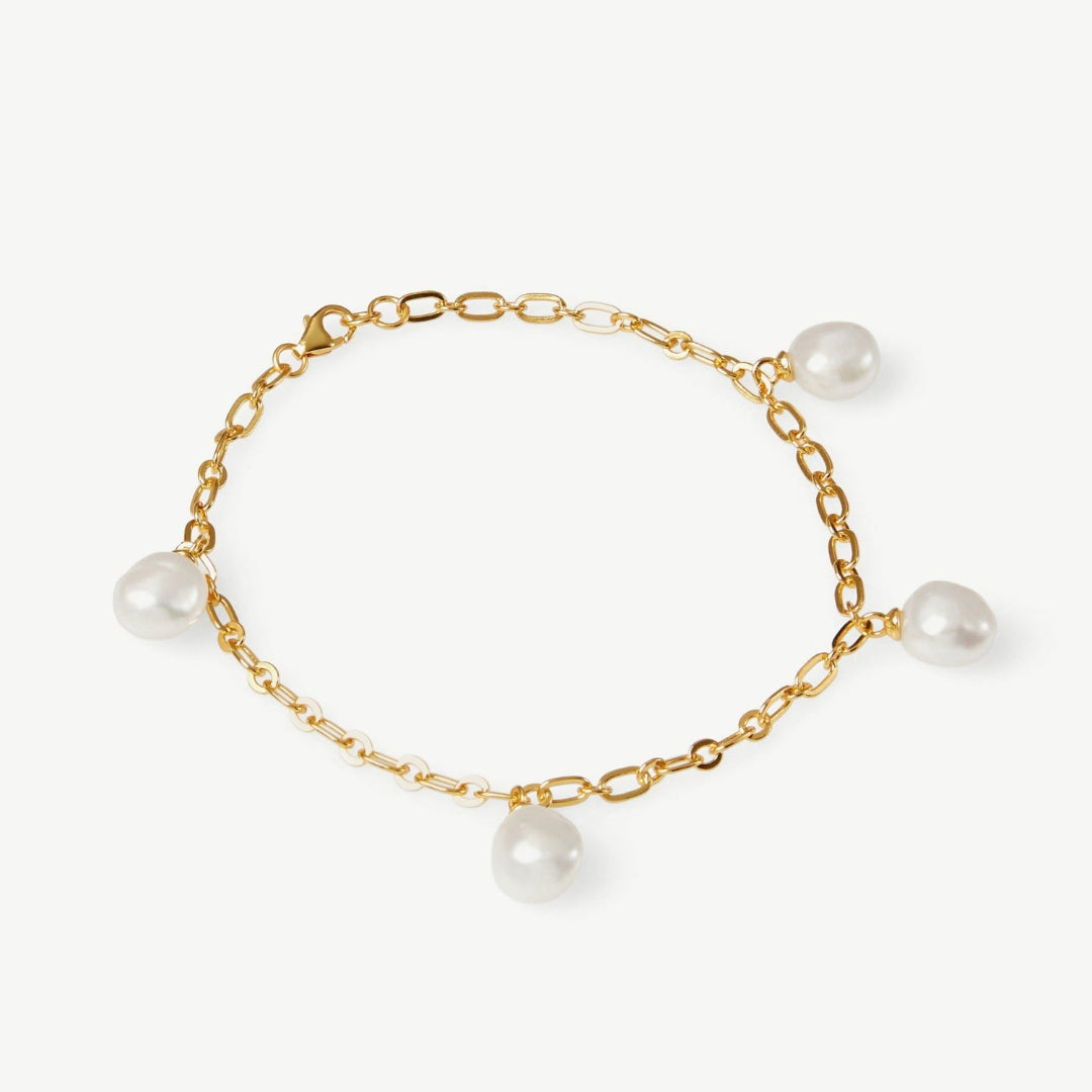 Gold bracelet with pearls on a white background
