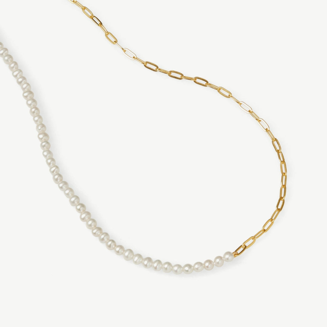 Necklace with pearl beads and gold chain on a white background