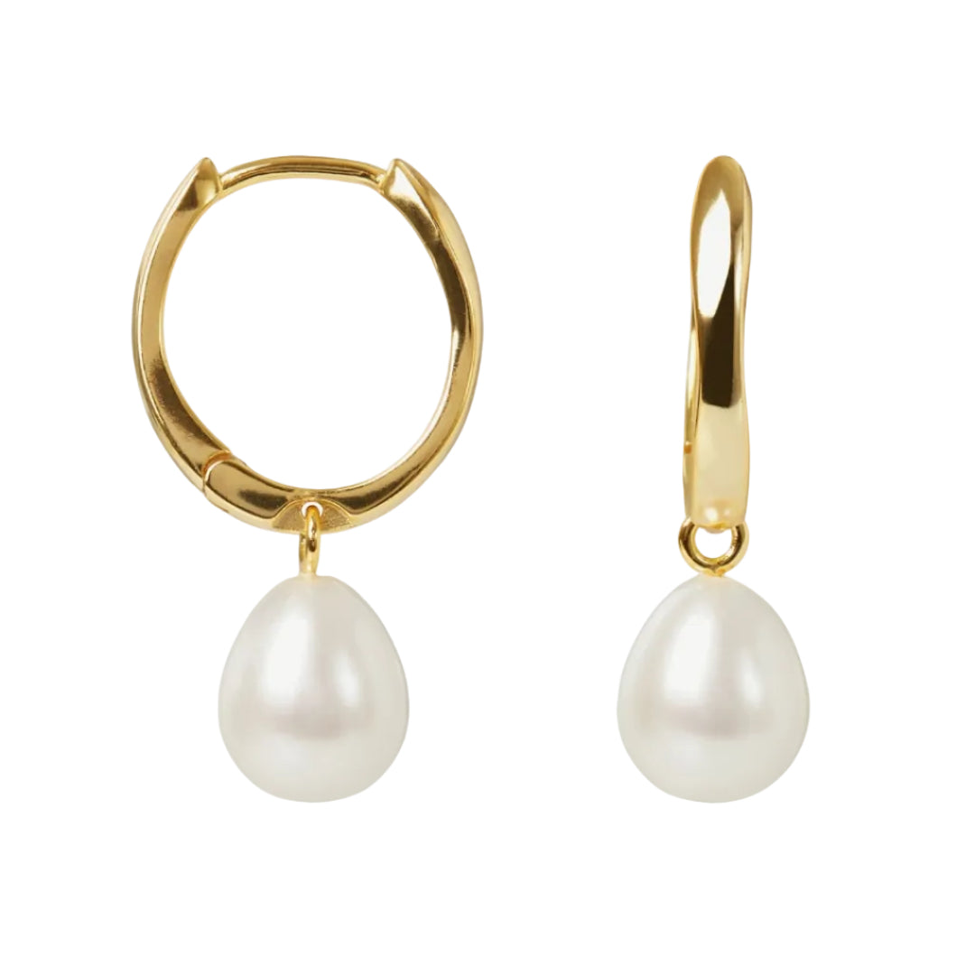 Gold hoop earrings with white pearls on a white background