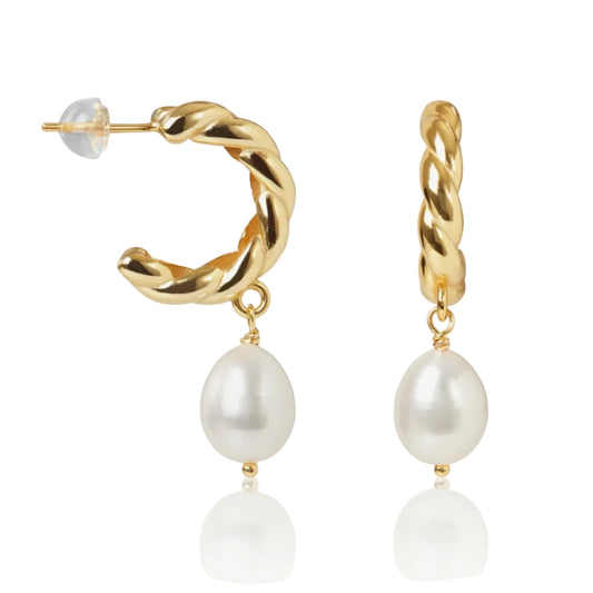 Gold hoop earrings with pearl drops on a white background