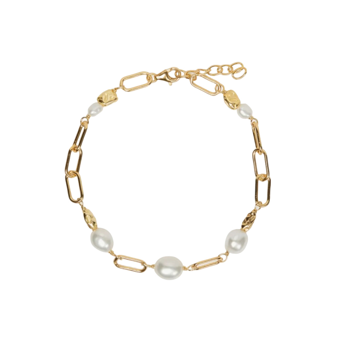 Gold chain bracelet with pearls on a white background
