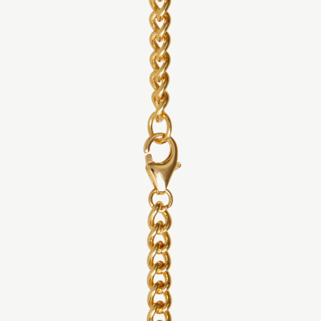 Gold chain necklace with clasp on a white background