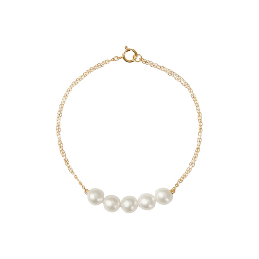Gold bracelet with pearls on a white background