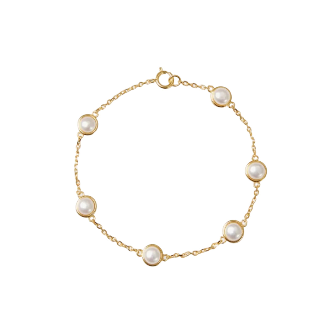 Gold bracelet with pearl beads on a white background