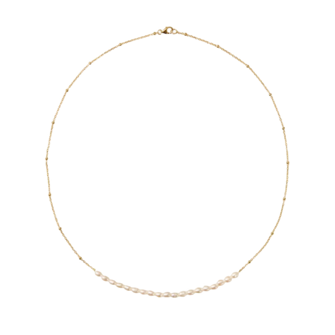 Delicate gold necklace with small beads on a white background