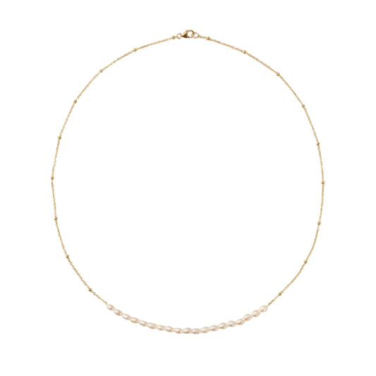 Delicate gold necklace with small beads on a white background