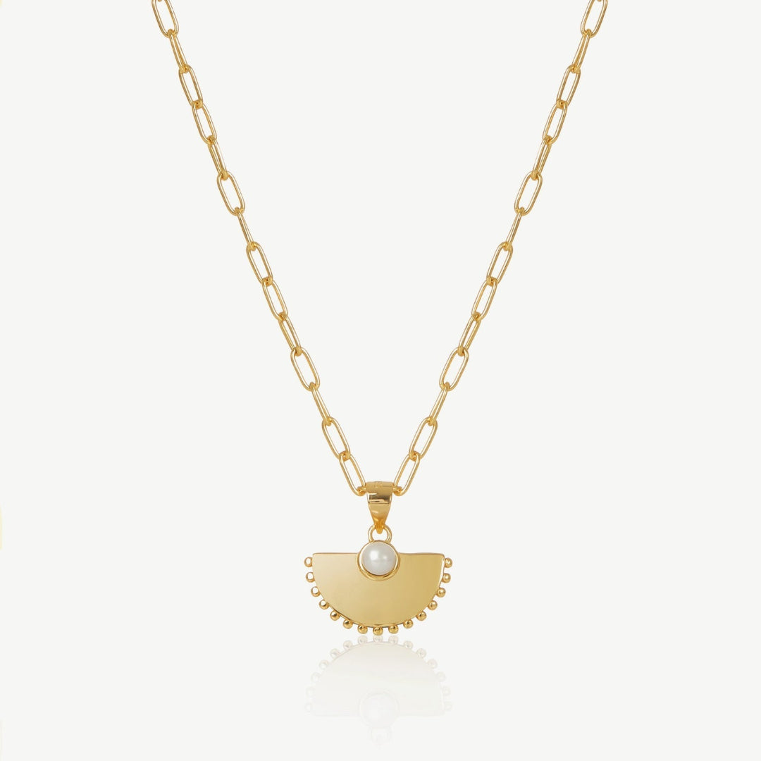 Gold necklace with a unique pendant on a white background