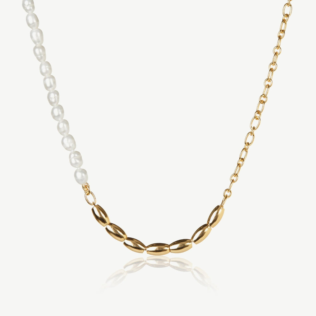 Necklace with gold chain and pearl beads on a white background