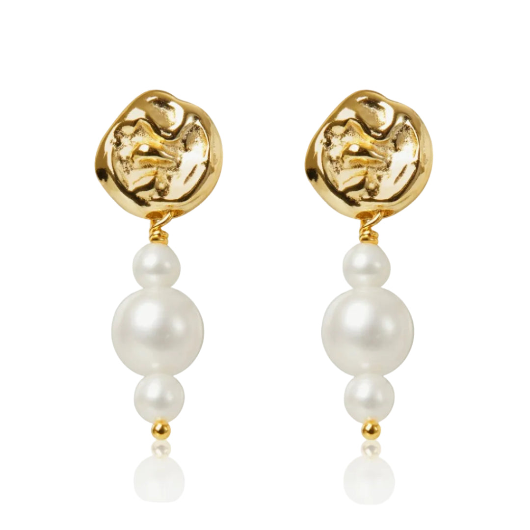Gold earrings with pearl drops on a white background