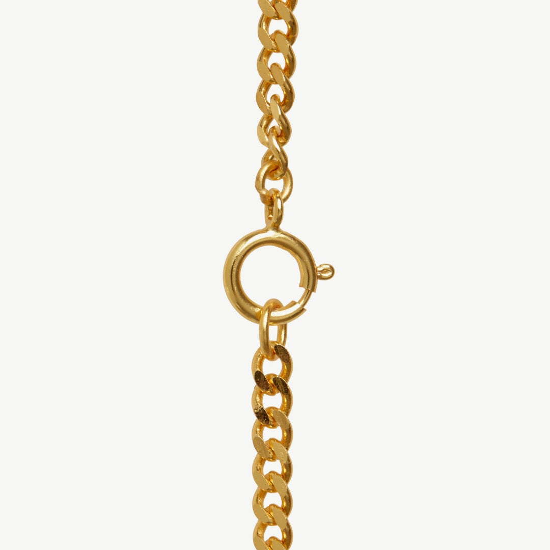 Gold chain necklace with clasp on a white background