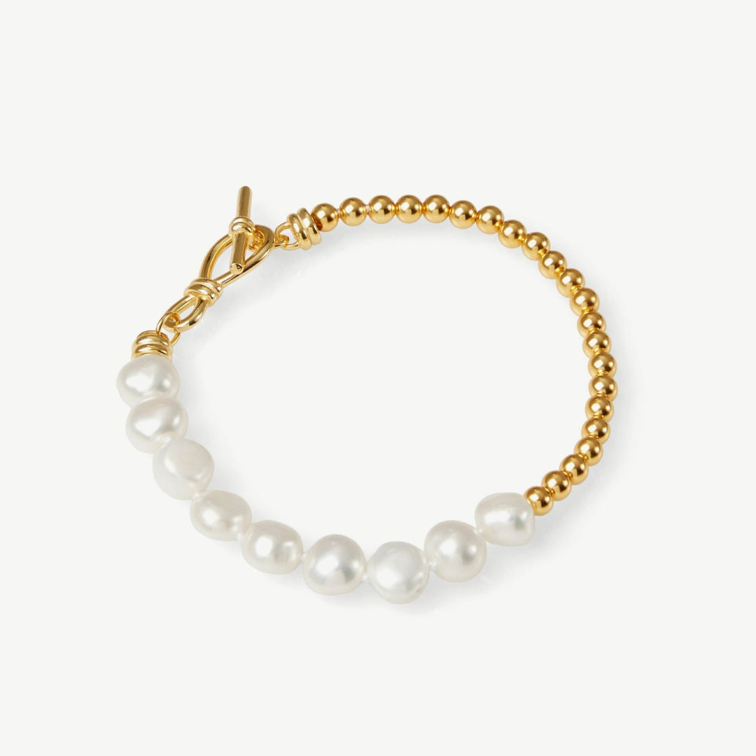 Pearl bracelet with gold chain on a white background