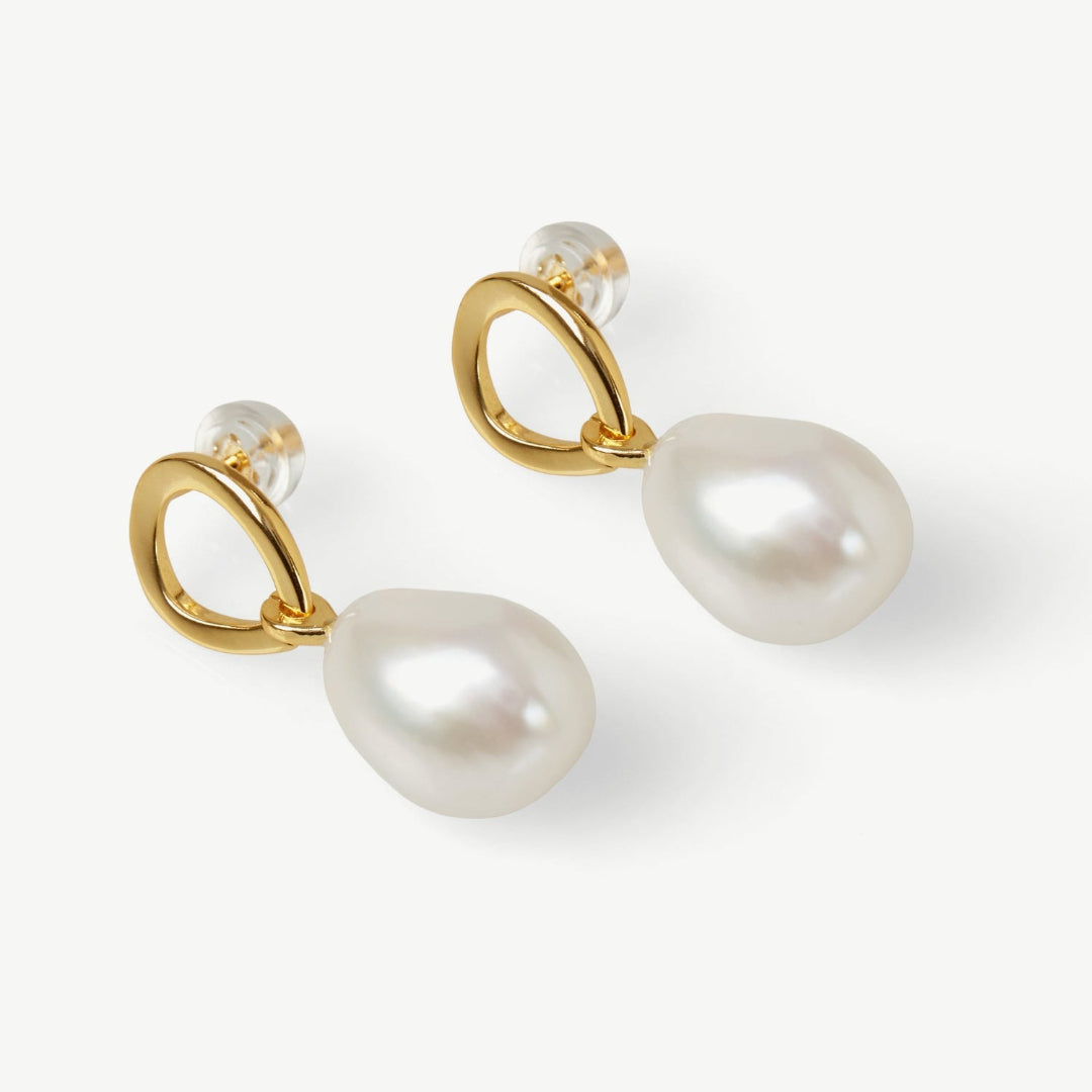 Pearl earrings with gold hooks on a white background