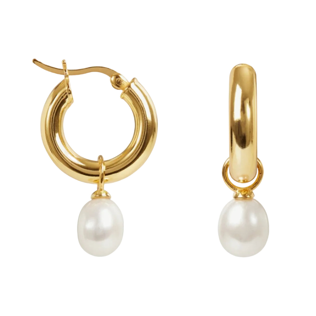 Gold hoop earrings with pearl drops on a white background