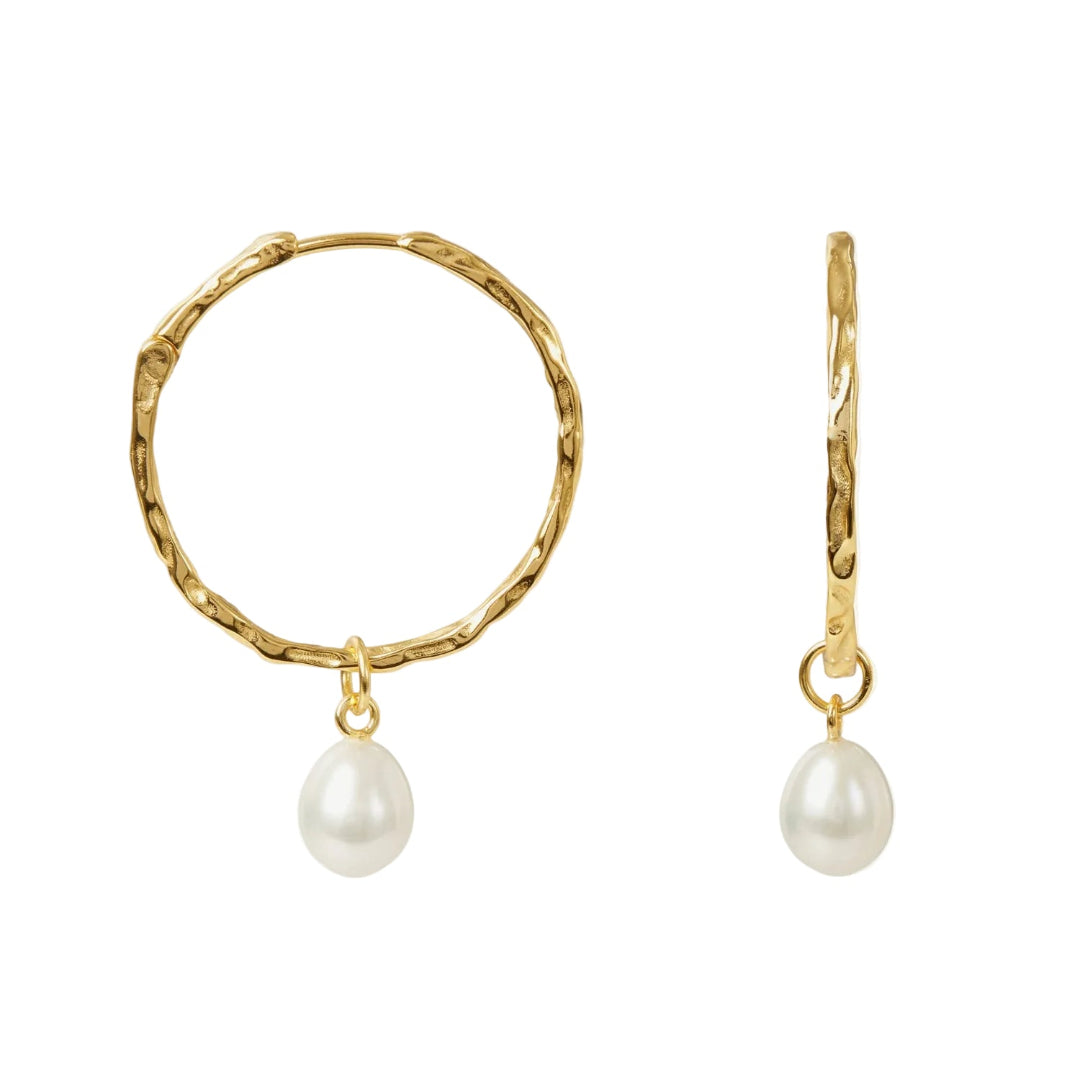 Gold hoop earrings with pearl drops on a white background