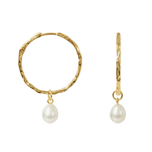Gold hoop earrings with pearl drops on a white background