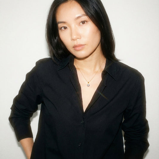 Woman wearing a black shirt against a white background